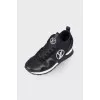 Black sneakers with brand logo