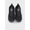 Black sneakers with brand logo