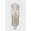 Dress with ruffles and a slit at the hem