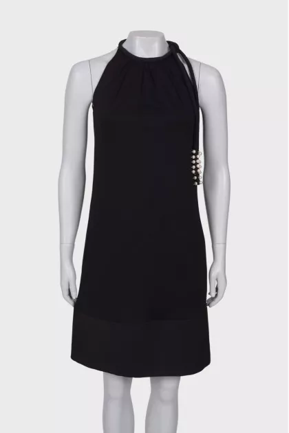 Black dress with ties and pearls