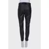 Black eco-leather trousers with tag