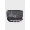 Leather bag with embellished shoulder strap
