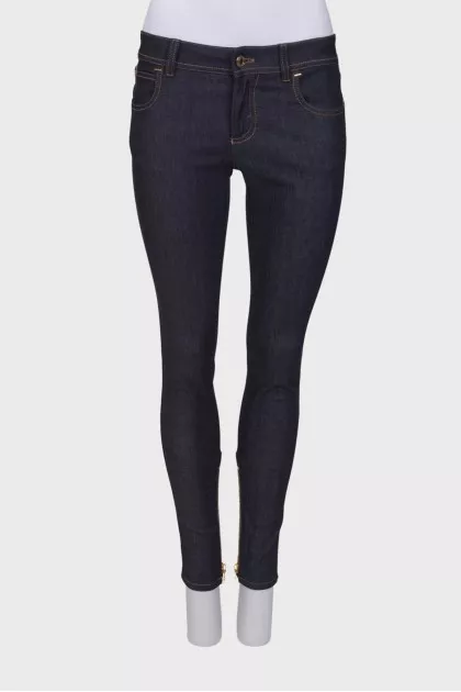 Navy blue jeans with a zip at the bottom