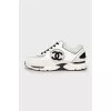 Black and white sneakers with brand logo