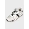Black and white sneakers with brand logo