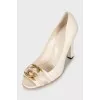 White shoes with golden logo