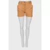 Beige shorts with buttons
