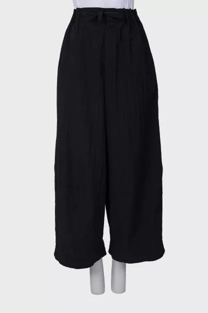 Black trousers with drawstring bottom