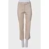 Beige pants with asymmetrical seams