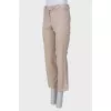 Beige pants with asymmetrical seams