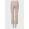 Beige pants with asymmetrical seams