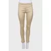 Beige trousers with slits at the bottom
