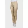 Beige trousers with slits at the bottom