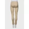 Beige trousers with slits at the bottom