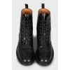 Black boots with perforated leather