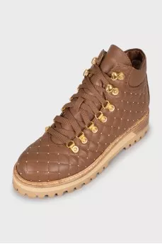 Insulated boots with gold hardware
