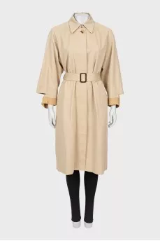 Beige trench coat with slits on the sleeves