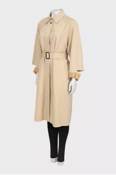 Beige trench coat with slits on the sleeves