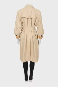 Beige trench coat with slits on the sleeves