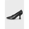 Black shoes with a shaped heel 
