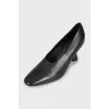 Black shoes with a shaped heel 