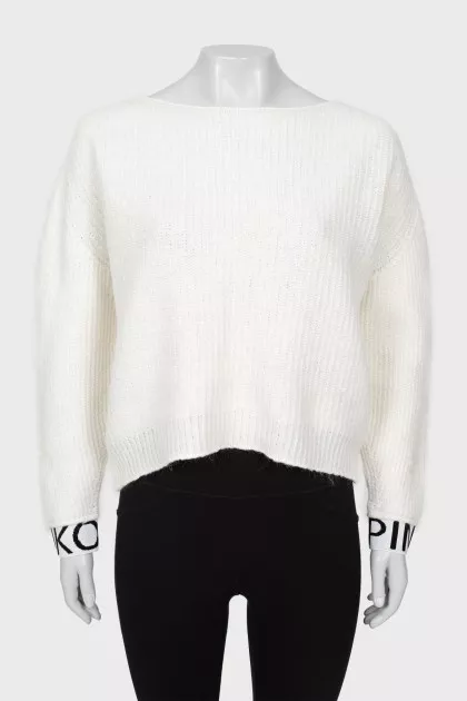 White sweater with logo on cuffs