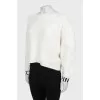 White sweater with logo on cuffs