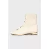 White boots with decorated perforations