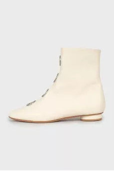 White boots with decorated perforations
