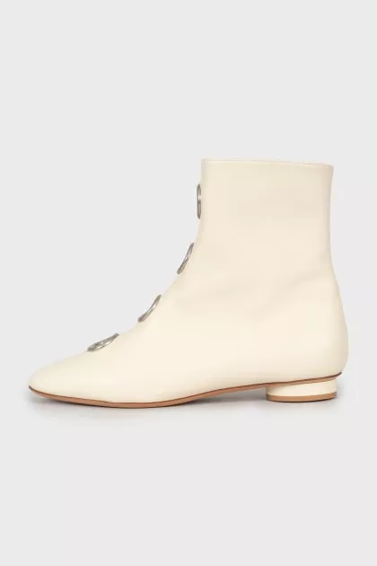 White boots with decorated perforations