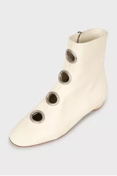 White boots with decorated perforations