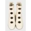 White boots with decorated perforations