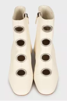 White boots with decorated perforations