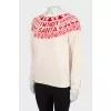 Milky sweater with red pattern