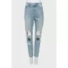 Ripped effect embellished jeans