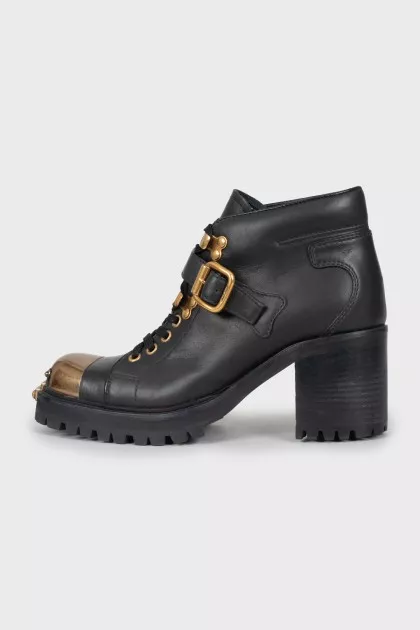 Black boots with gold toe