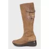 Suede boots decorated with buckles