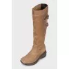 Suede boots decorated with buckles
