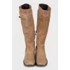 Suede boots decorated with buckles