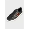 Black leather sneakers with decor