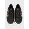 Black leather sneakers with decor