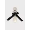 Logo brooch with pearls