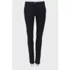 Black trousers with stitched creases