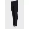 Black trousers with stitched creases