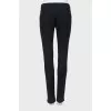 Black trousers with stitched creases