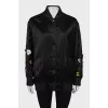 Black bomber jacket decorated with flowers