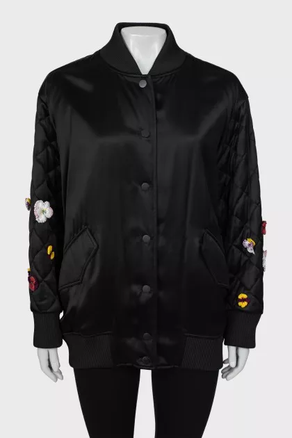 Black bomber jacket decorated with flowers