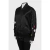 Black bomber jacket decorated with flowers