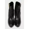 Leather ankle boots decorated with zippers