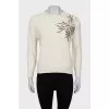 Knitted sweater decorated with sequins